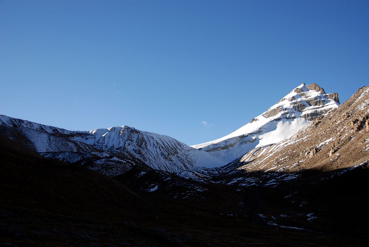 47 Khandro Sanglam La The Secret Path of the Dakini Khandroma Is An Alternative Route Around Mount Kailash In The Early Morning Sun From Shiva Tsal On Mount Kailash Outer Kora Across the valley from Shiva Tsal, a trail branches off to the southeast over the snow-covered Khandro Sanglam La, the Secret Path of the Dakini Khandroma. This alternative route around Kailash bypasses the D�lma La, which tradition says can only be crossed if you have completed 12 previous koras.